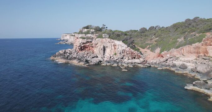 Aerial view of Mallorca rocky coast with clear turquoise Mediterranean Sea