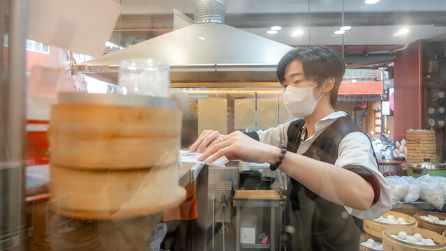 Taiwanese restaurant chef preparing xiaolongbao dumplings