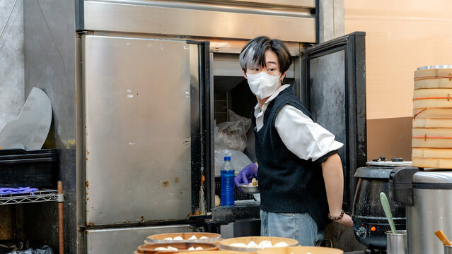 Taiwanese restaurant staff preparing xiaolongbao dumplings