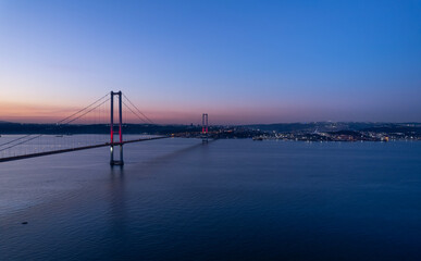 Fototapeta premium Osmangazi Bridge in Kocaeli, Turkey. Aerial shot with drone. Beautiful sunset landscape.