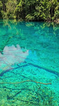 Transparent crystal lake with fresh water in Indonesia. Danau Paisu pok