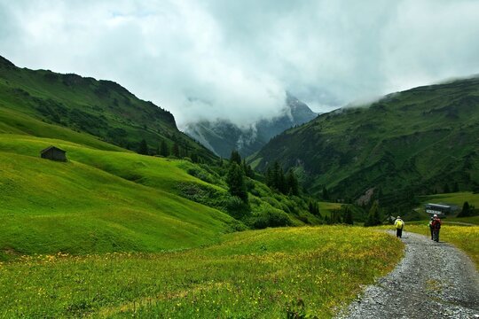 Austrian Alps - view of a tourists on a path near the mount Kriegerhorn to the town of Lech in the Lechtal Alps
