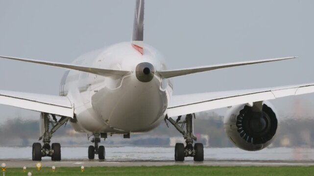 Large white passenger aircraft preparing for takeoff on runway, rear close up view, engines spooling up in hot sunny conditions, strong heat haze distortion, cinematic slow motion aviation scene