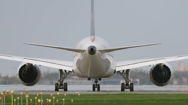 Large white passenger aircraft preparing for takeoff on runway, rear close up view, engines spooling up in hot sunny conditions, strong heat haze distortion, cinematic slow motion aviation scene