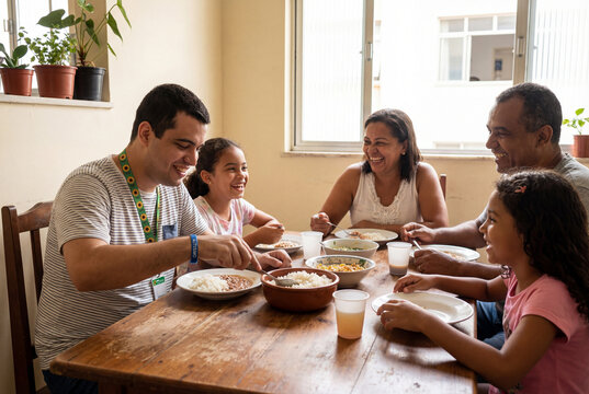 Happy family eating lunch together at home