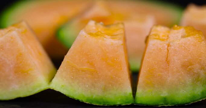 ripe juicy orange melon cut into pieces on a cutting board, sweet pumpkin with juicy soft orange flesh cut into pieces, cantaloupe slice