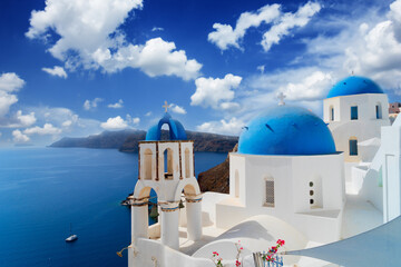 traditional greek village Oia of Santorini, with blue domes against sea and caldera, Greece © neirfy