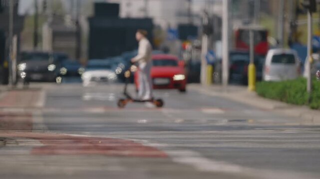 Blurred city traffic approaching from low angle, strong bokeh and heat haze over hot asphalt, dynamic abstract transportation scene in bright daylight