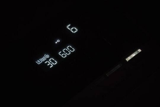 Countdown digits on a top-loading washing machine display.