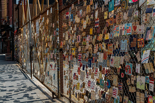 Tiles painted and hung on a fence to memorialize in New York City 
