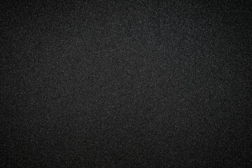 Fototapeta premium Background of smooth black surface with subtle texture and shine seen in close view during daylight hours