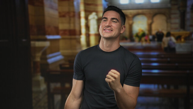 Man clenching fists inside church building with tense face and clenched jaw; faith struggle determination.
