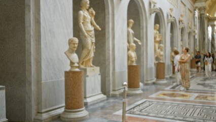 Fototapeta premium Blurred museum interior with classical marble statues, arches and polished mosaic floor in shallow bokeh; background backdrop copyspace calm.