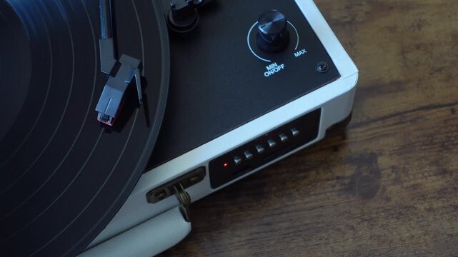 Vinyl record spinning on turntable top view. Analog music playback close up