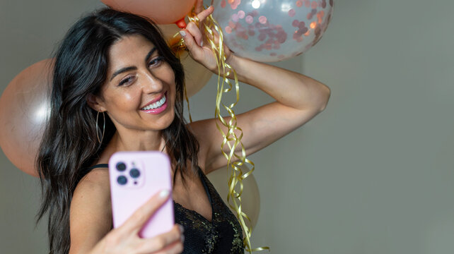 Beautiful woman celebrating birthday with balloons 
