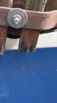 water dripping from metal pipe detail for leak concept with close up drops and industrial surface