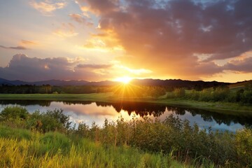 Fototapeta premium Sun Sets Over a Lake With Reflection of Clouds and Mountains in the Background During Evening Hours