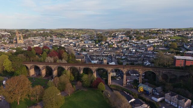 Aerial drone footage of the Carvedras Viaduct in Truro, Cornwall, showcasing a historic railway bridge set within an urban landscape