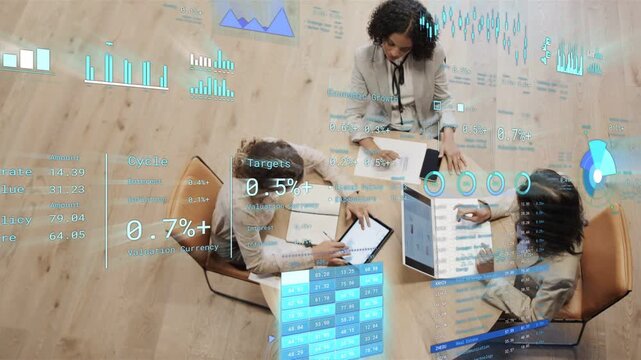 Three female colleagues taking notes, using tablet, laptop while following business metrics overlay