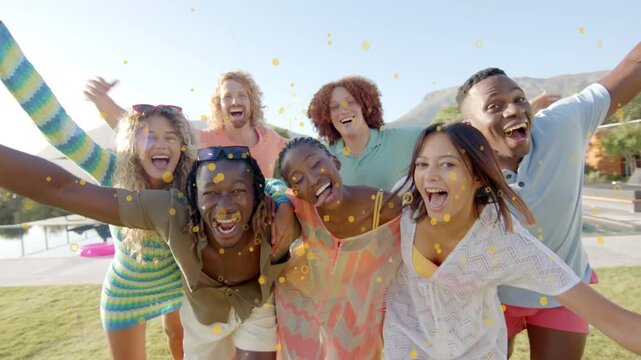 7 adults leaning toward camera poolside, camera moving, confetti floating over group for marketing