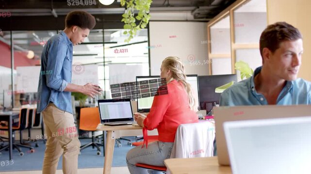 Man walking with phone, causing animated chart on screen while woman checking laptop for business