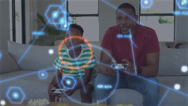 Dad and son gaming on sofa, pressing controllers activating blue hologram overlay, bonding
