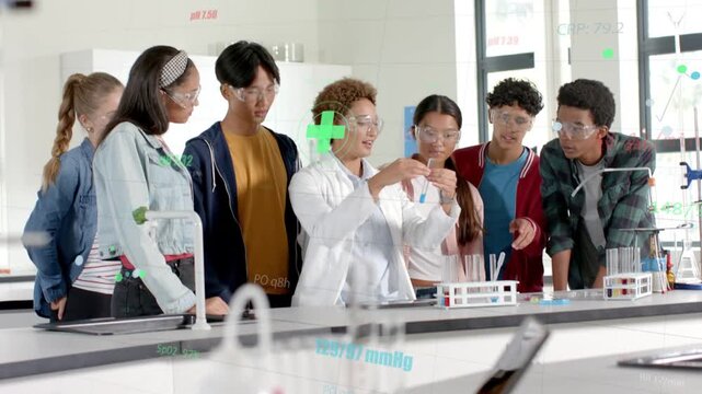 Instructor leading chem lab reaching test tube and urging pupils holding tubes as AR showing data
