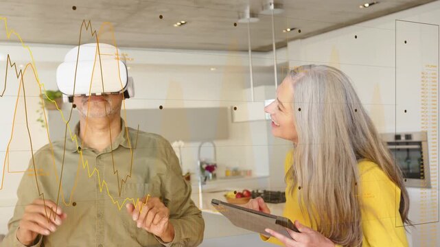 Man lifting white VR headset in kitchen, woman guiding via tablet, reaching objects for tech demo