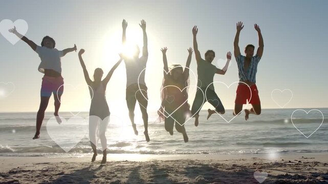 Friends bending knees on beach, launching synced jump celebrating travel with heart overlays