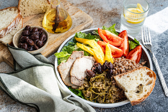 Rustic buckwheat lunch bowl with olives and sourdough