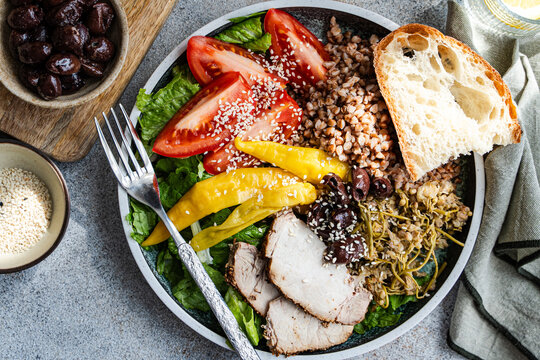 Wholesome buckwheat salad bowl with olives and bread