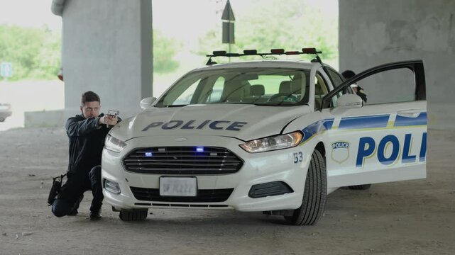 Teamwork two policemen leave the patrol car pulling pistols danger dangerous delinquent gangster gun gunpoint handgun hold illegal intruder law offender burglar close up slow motion