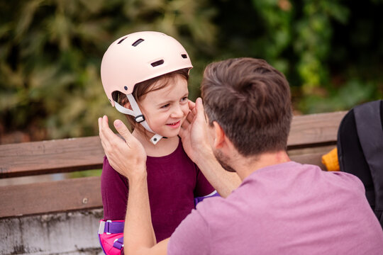 Father and daughter bonding over roller skating