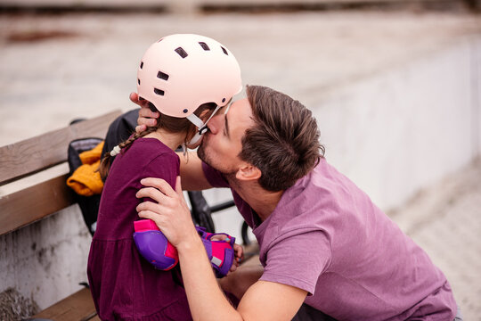 Father and daughter enjoying outdoor roller skating fun