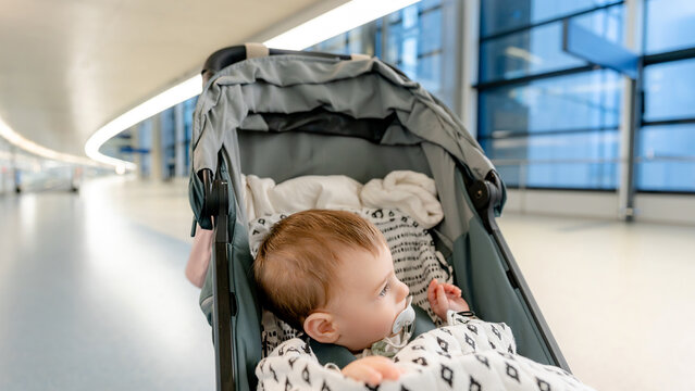 Baby in stroller at airport during family trip