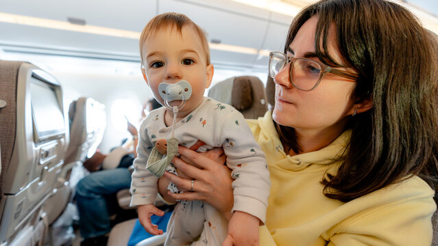 Family with baby on plane during travel adventure