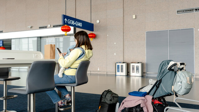 Mother and baby waiting at airport gate