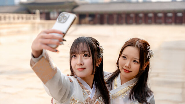 Women capturing memories in traditional hanbok