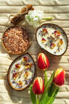 Spa still life with coconut candles, salt and tulips