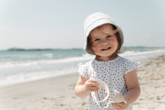 Little girl enjoying a sunny day at the beach