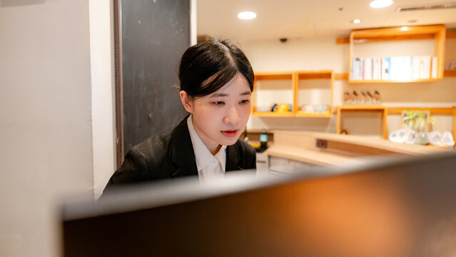 Taiwanese hotel receptionist working at front desk counter