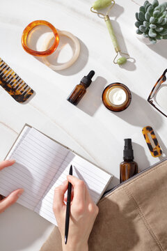 Writing journal with beauty items in slow morning routine