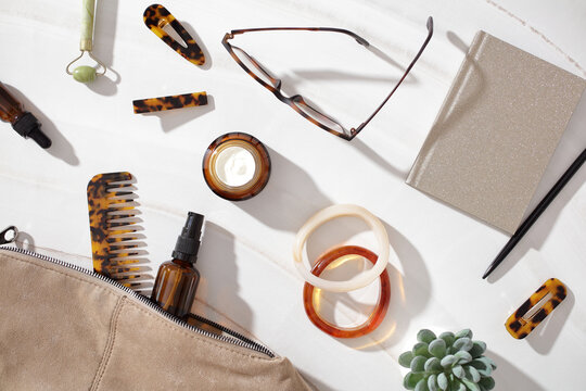 Flat lay of feminine beauty accessories and skincare items