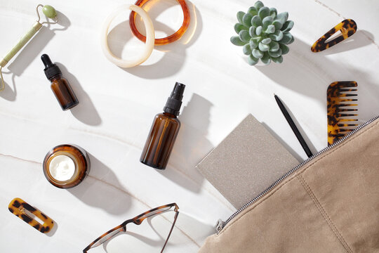 Minimal feminine beauty layout with skincare and accessories