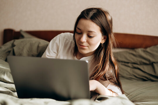 Relaxing day off enjoying bed rotting with a laptop