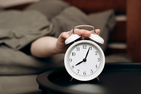 Peaceful morning with vintage white alarm clock