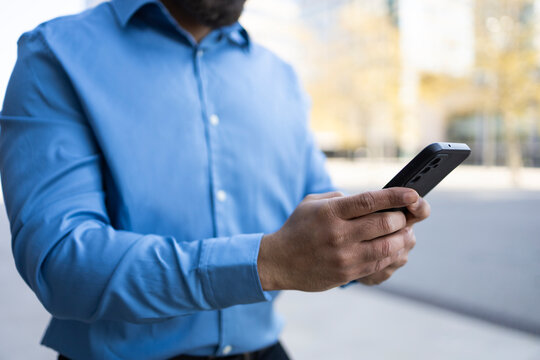 Businessman using smartphone for work communication on the go