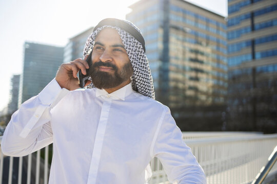 Arab businessman sheikh on phone in modern city district