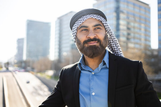 Arab businessman sheikh in city portrait with modern skyline