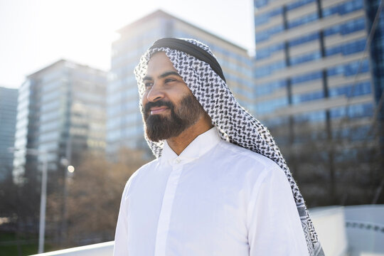 Arab businessman sheikh in traditional attire in modern city